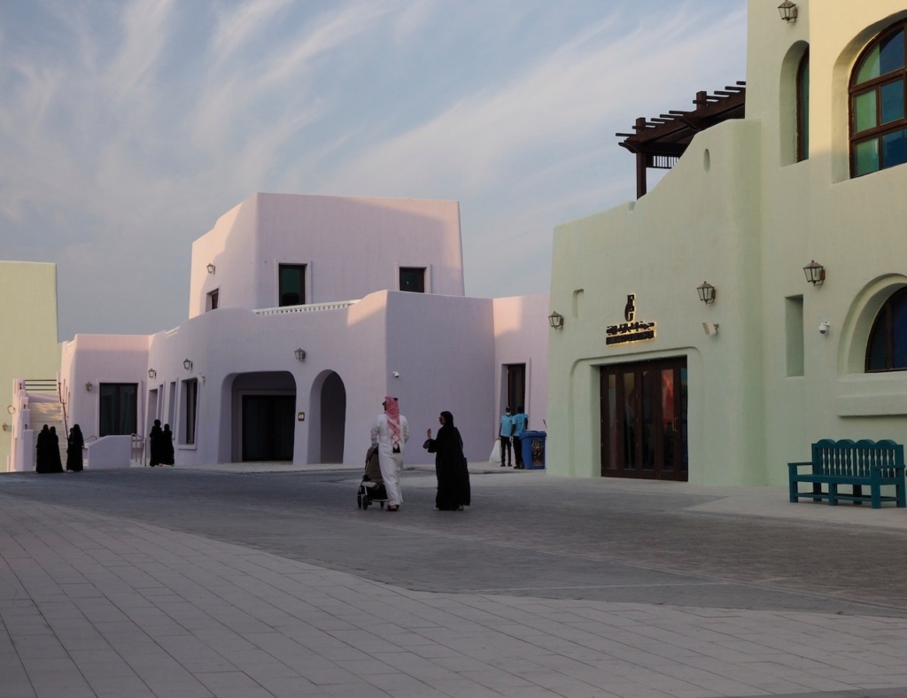 Photo of two people in front of a residence in Doha, Qatar.