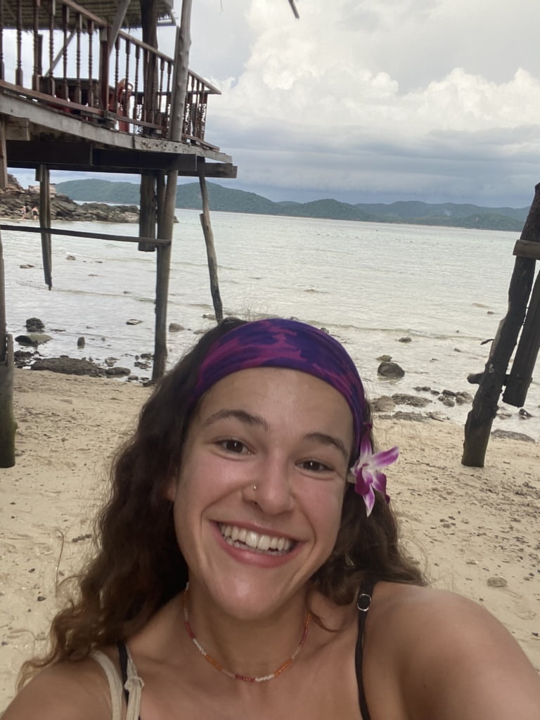 Me on a beach in Thailand, one of the best places to travel on a budget in Southeast Asia.