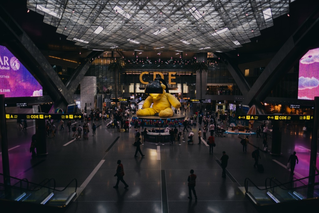 Photo of inside Doha International Airport, featuring the bear art piece in the center. 